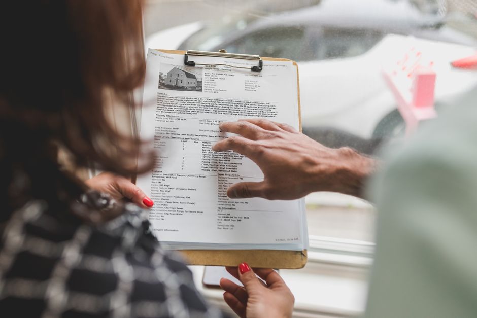 Real estate agent discussing property details with a client in Queensland