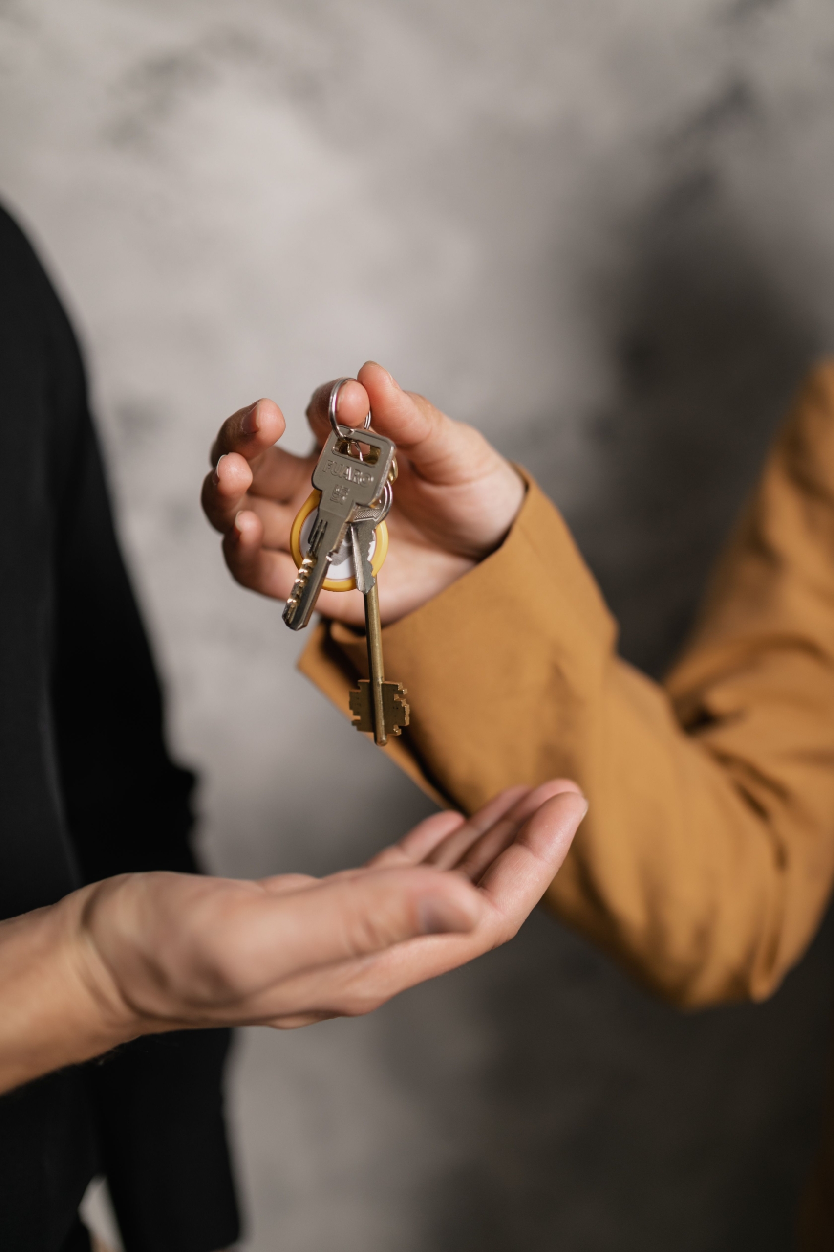 Property manager handing over keys to tenant in Australia
